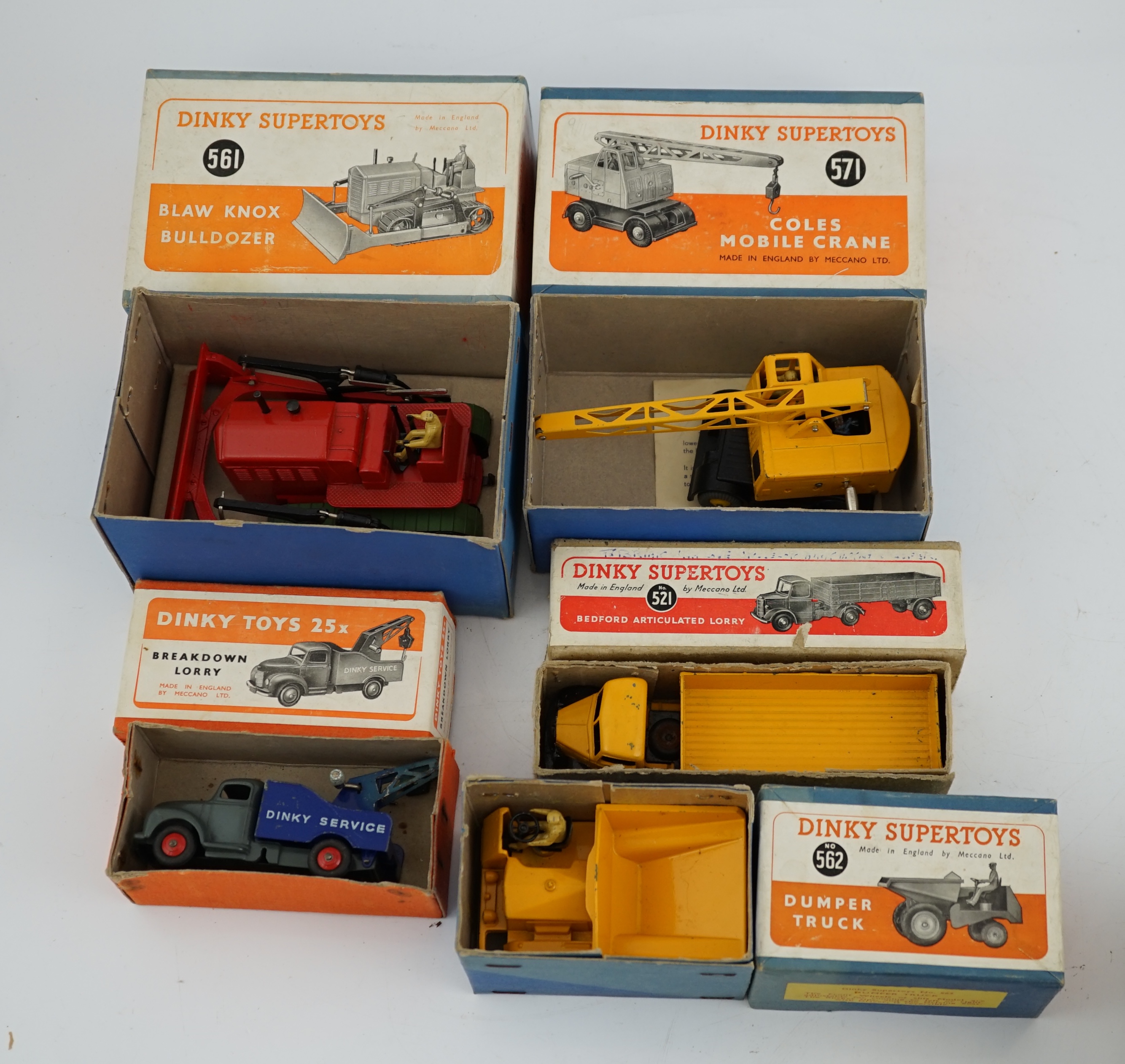 Five boxed Dinky Supertoys and Dinky Toys; a Breakdown Lorry (25x) dark grey with dark blue back, a Bedford Articulated Lorry (521) in yellow, a Blaw Knox Bulldozer (561) In red with green rubber tracks, a Dumper Truck (